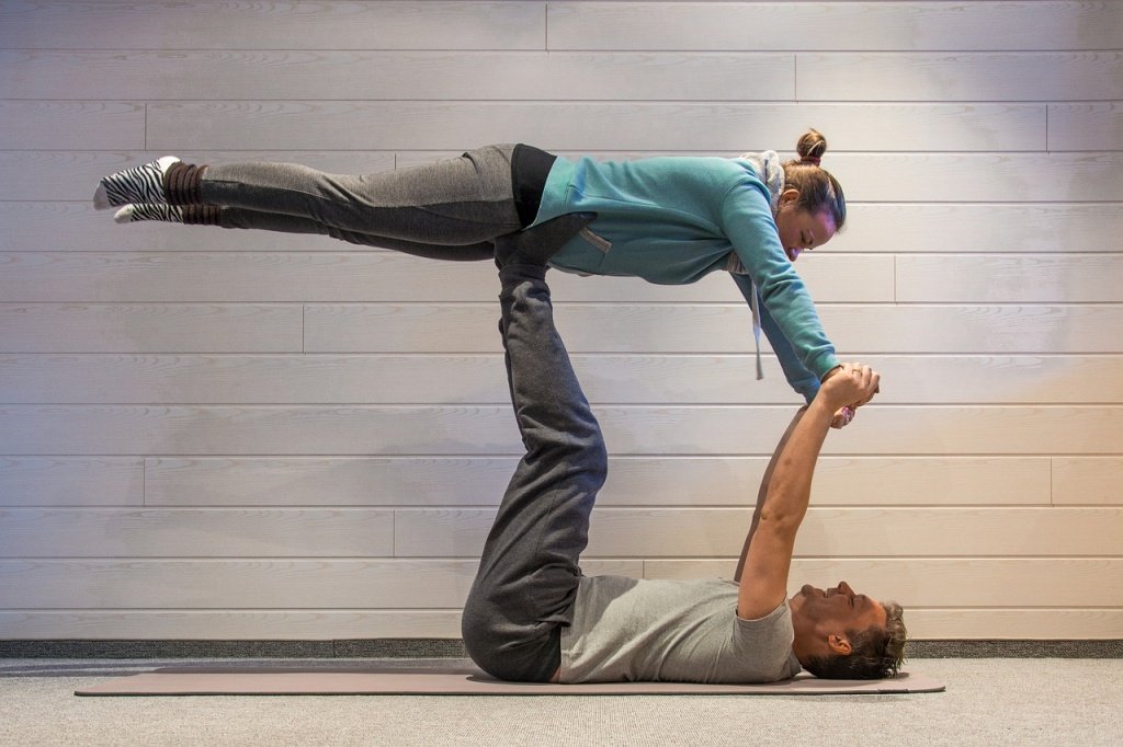 Three people practicing acroyoga in studio Stock Photo - Alamy