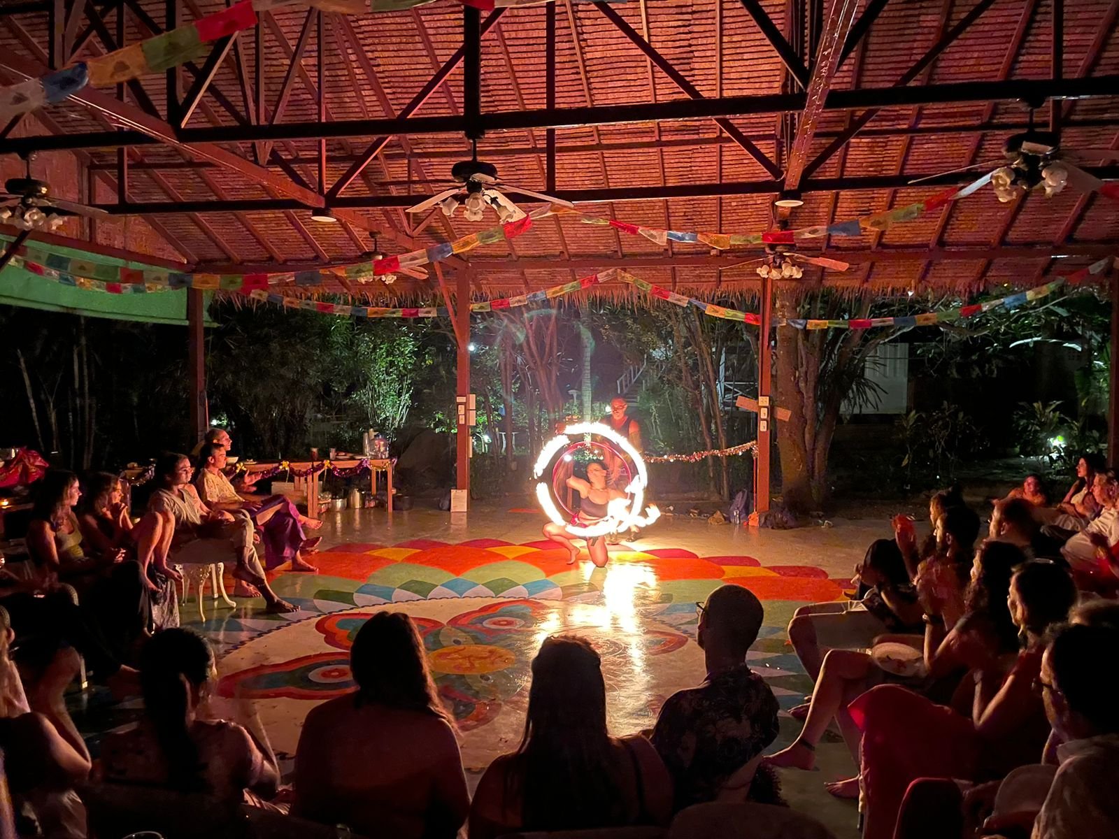 A couple in a meditative pose during a Tantra retreat in a serene, tropical setting in Thailand